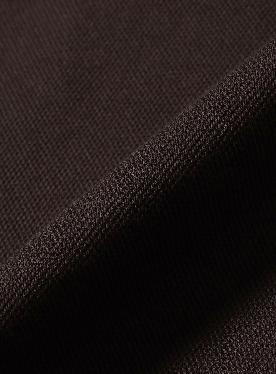 Close-up of a dark brown pique fabric featuring the signature twin-tip design on a textured knit [Exclusive] BEAMS x Fred Perry Pique Long Sleeve Polo Shirt.