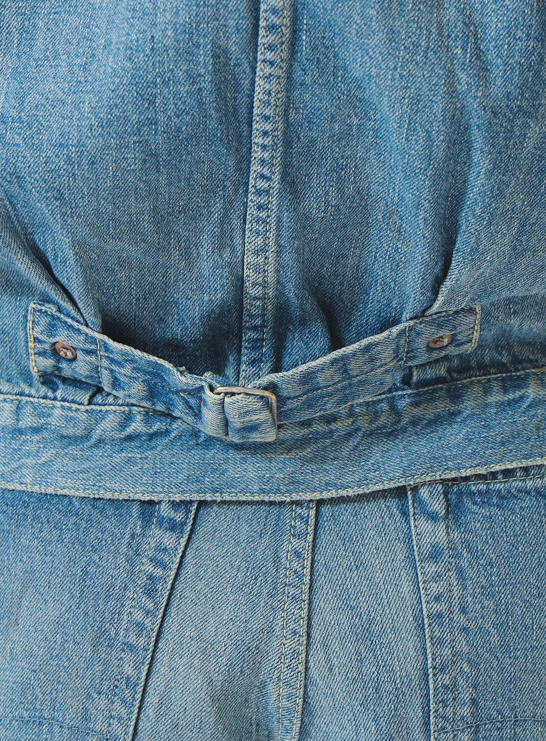 Close-up of a blue denim jacket with stitching details