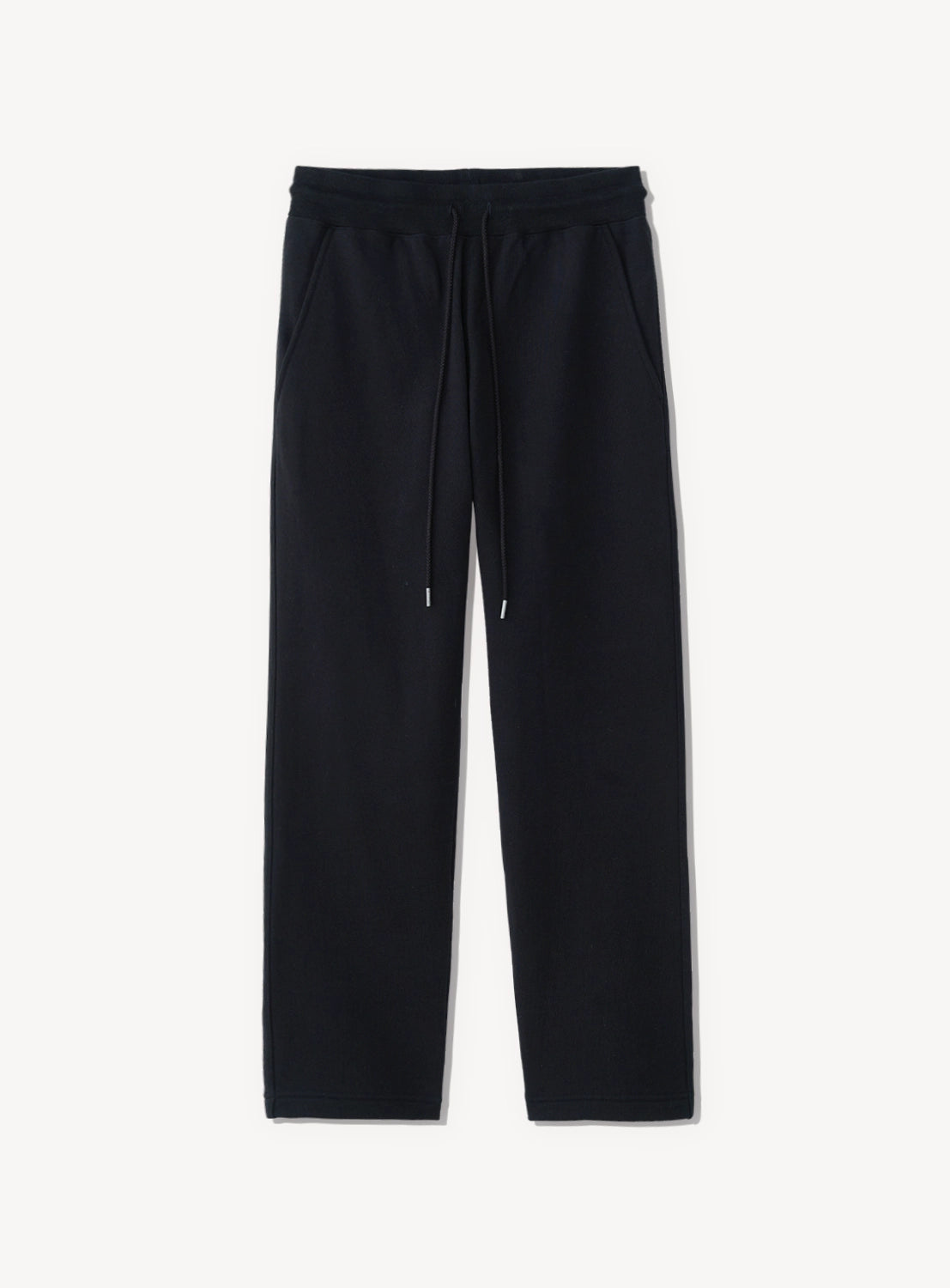 Black tapered pants with a drawstring at the waist. 