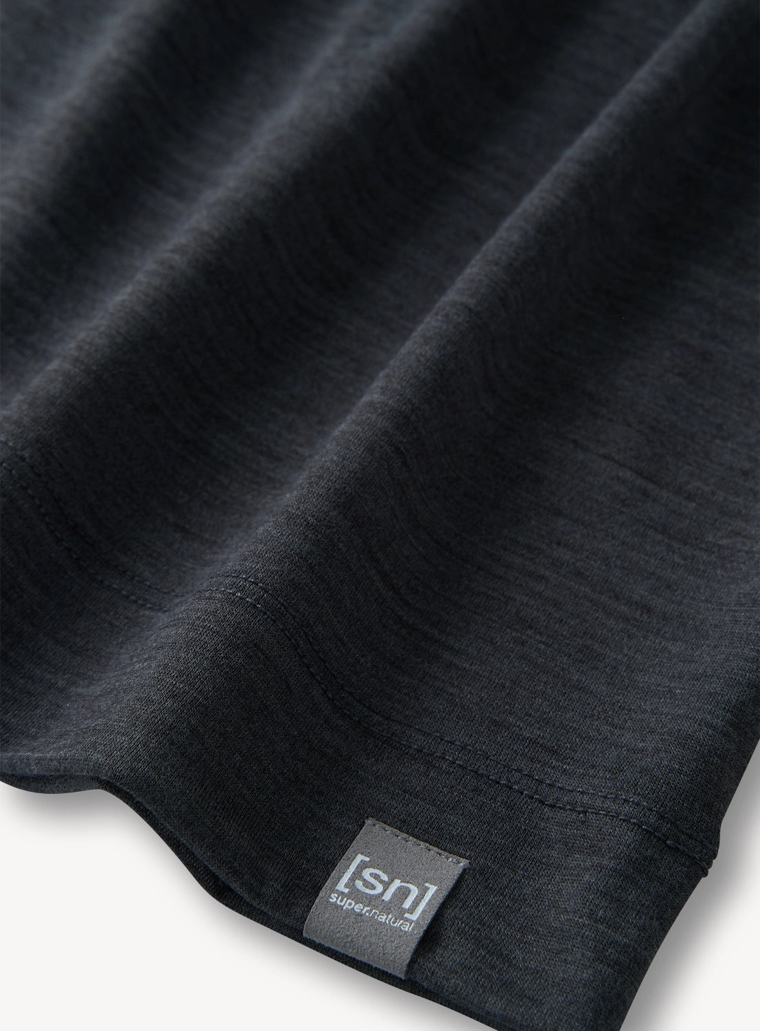 Close-up of a grey tank top with a visible brand label.