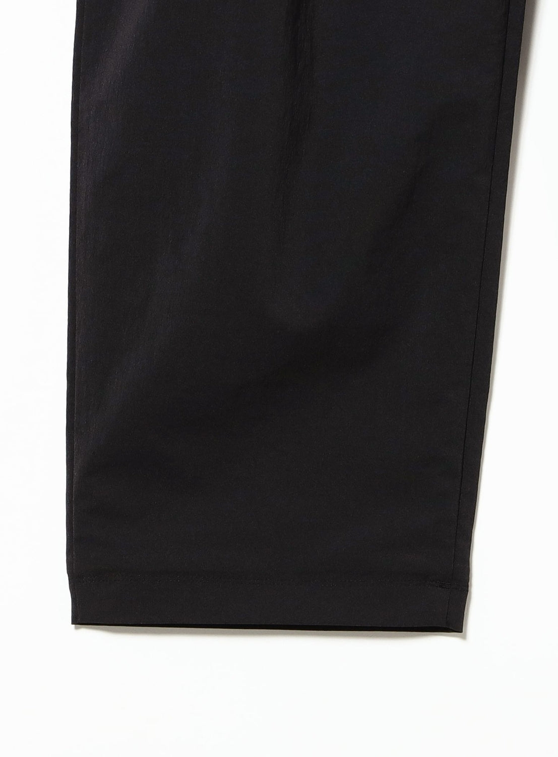 Close-up of the lower portion of a pair of black TEATORA Wallet Pants Resort - Doctoroid against a white background, highlighting the straight leg hem and smooth DOCTOROID fabric.