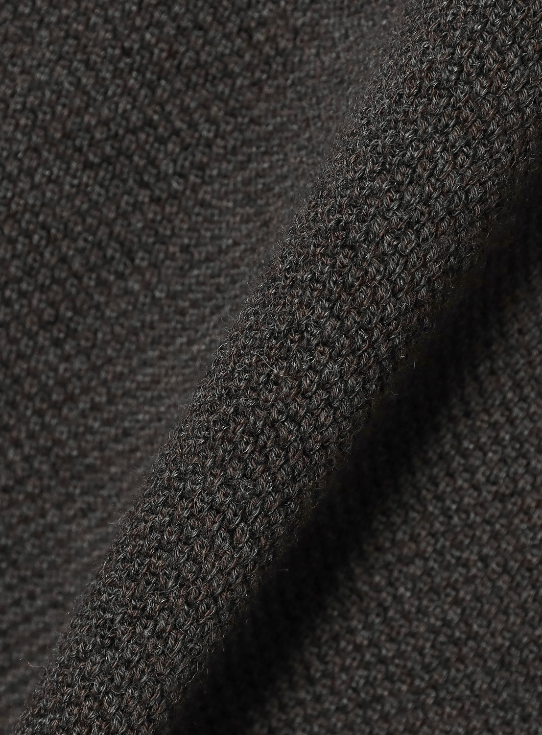 Close-up of dark gray textured fabric.