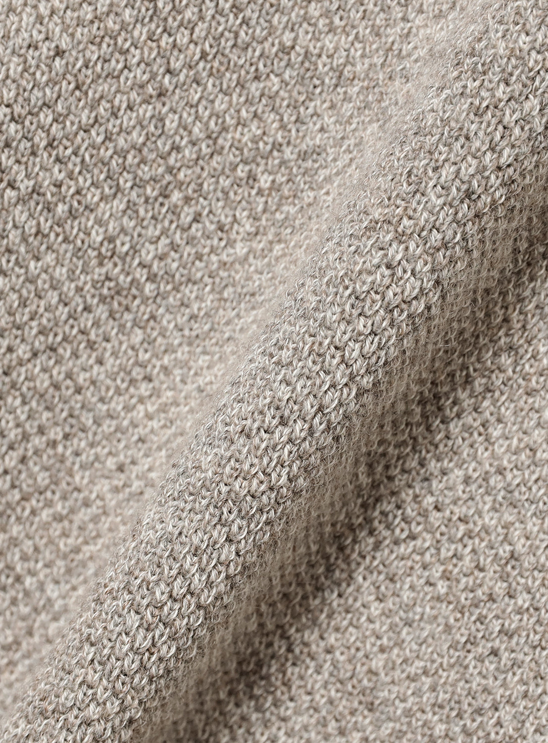Close-up of textured beige fabric.