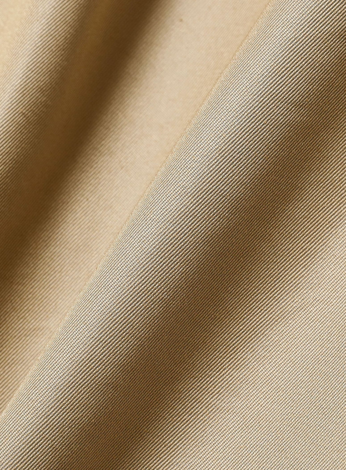 Close-up of tan wrinkle-resistant BEAMS Chambray Chino Pants with a visible diagonal twill weave.