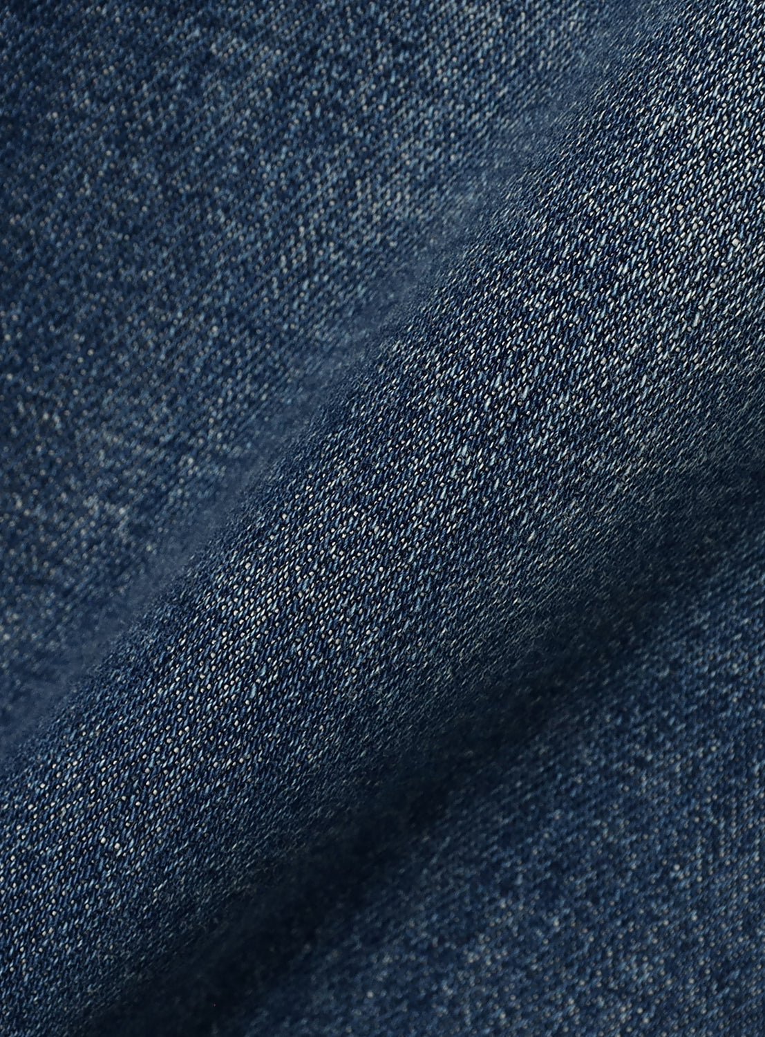 Close-up of folded dark blue BEAMS Comfy 5-Pocket Denim in Japanese stretch fabric.