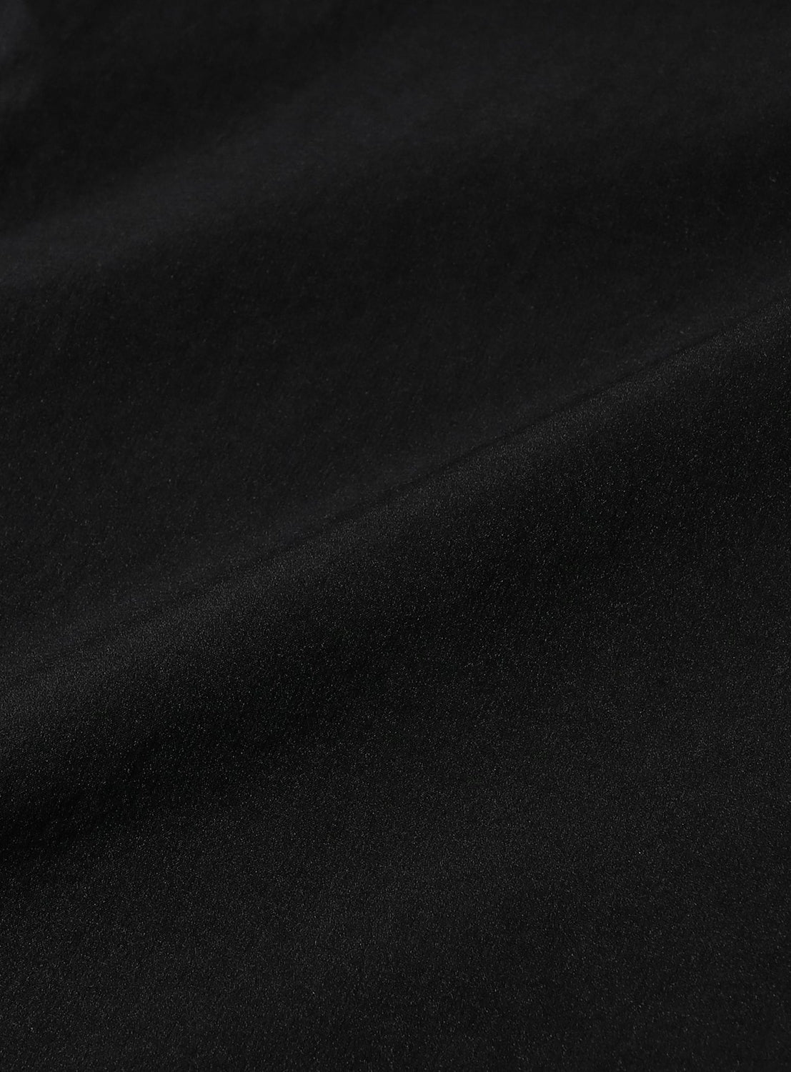Close-up view of black stretch double-weave fabric on Technical 2-Way Adjustable Easy Pants with a subtle diagonal fold.