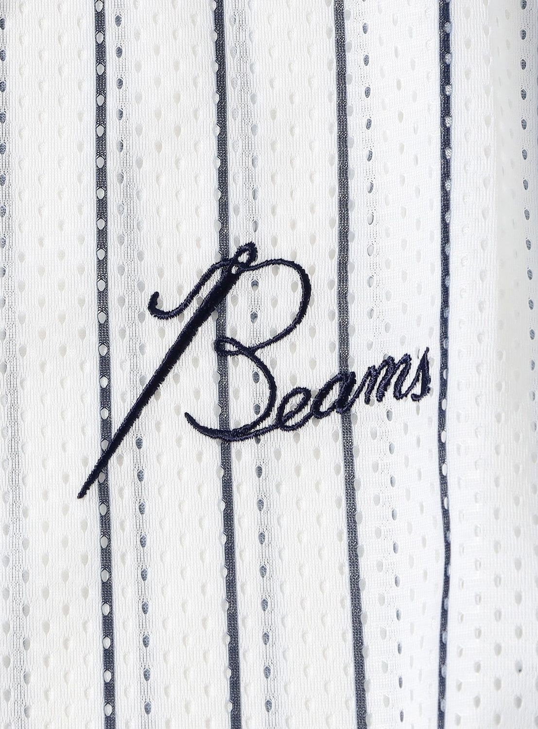 Crafted from white fabric adorned with vertical blue pinstripes and subtle perforations, the [Exclusive] Needles 50th Baseball Shirt by NEEDLES features “Beams” embroidered in blue cursive lettering. A perfect fusion of timeless athletic design and streetwear flair, this standout piece celebrates the coveted BEAMS x NEEDLES collaboration—making it an essential addition to any contemporary wardrobe.
