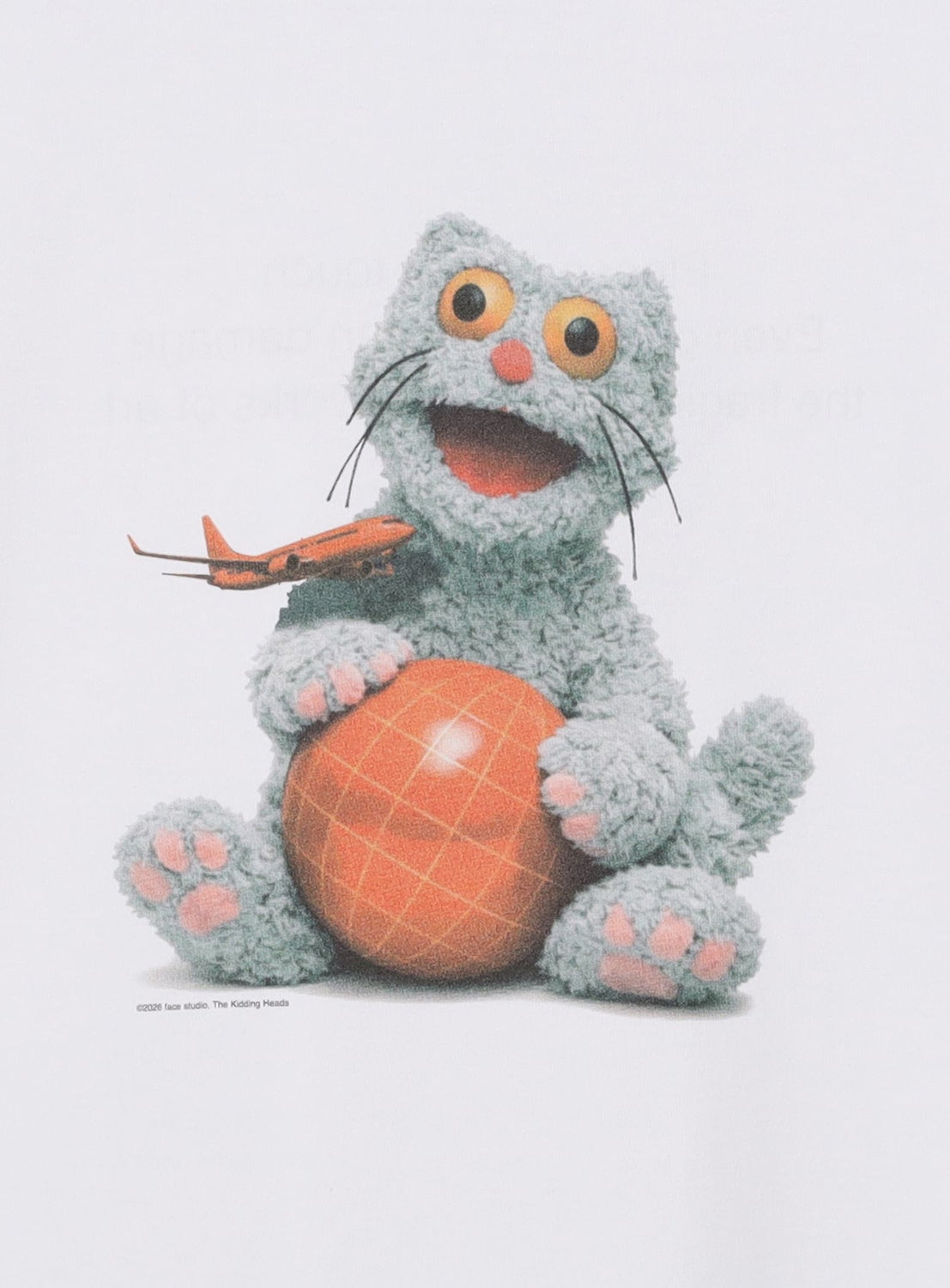 A fluffy blue cartoon cat with pink paws holds an orange grid-patterned ball, grinning wide-eyed, while a small toy plane perches on its paw—commemorating the BEAMS T x FACE Graphic T-Shirt for BEAMS 50th anniversary.