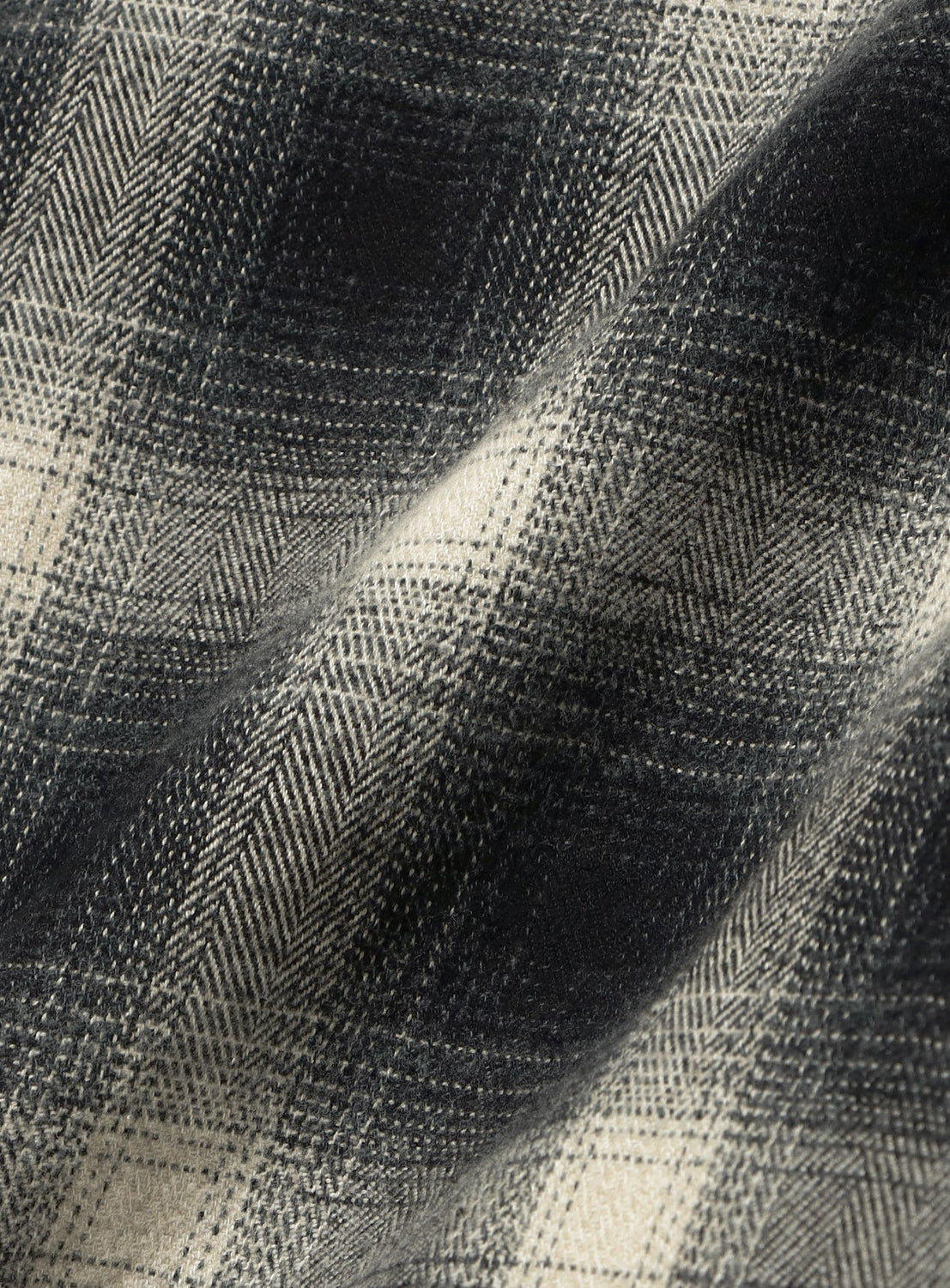 Close-up of BEAMS Check Shorts in black and white ombre fabric featuring a herringbone weave pattern in a relaxed fit.
