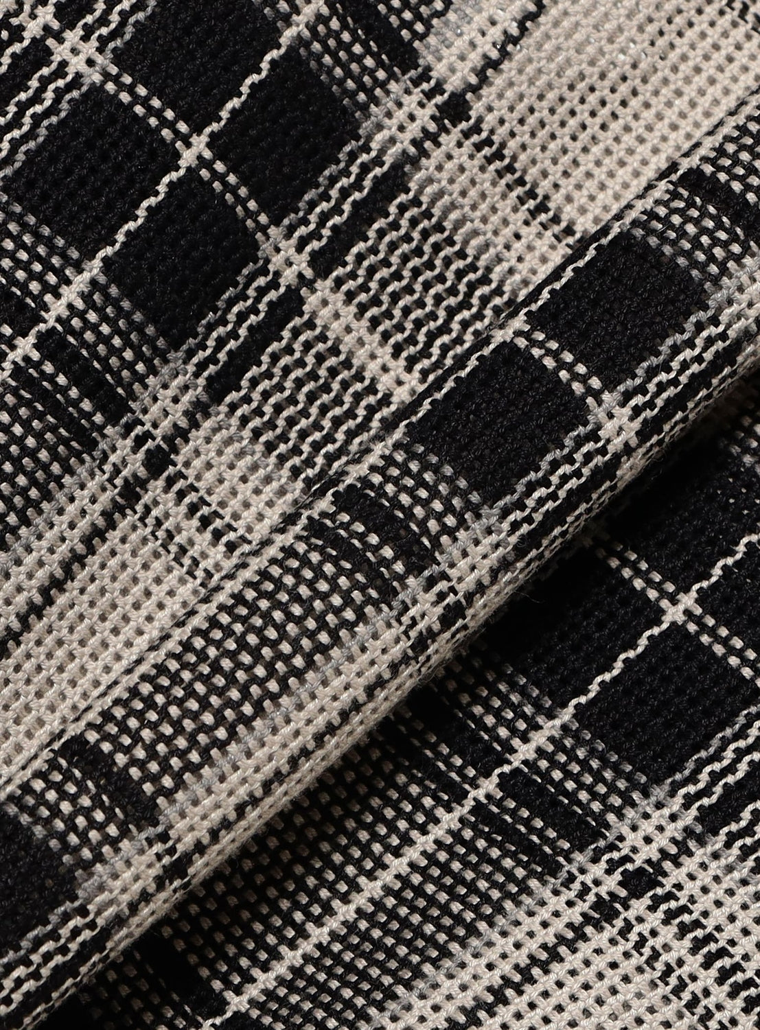 Close-up of the BEAMS Classic Check Mesh Zip-Up Shirt, featuring a black and white checkered mesh fabric in a relaxed silhouette with a visible grid texture.