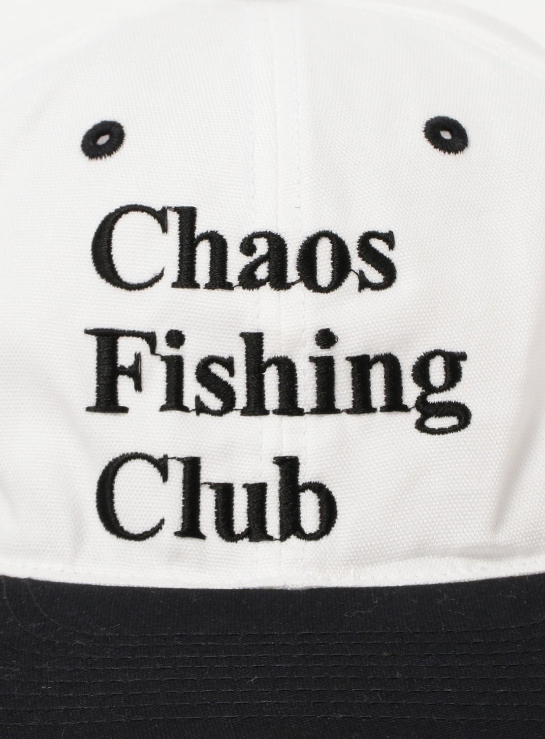 The Chaos Fishing Club Logo Cap by Chaos Fishing Club features a minimalist white design with black embroidered text reading the brand's name on the front. The cap is accented with a black brim, two top eyelets, and the signature logo for a clean, stylish look.