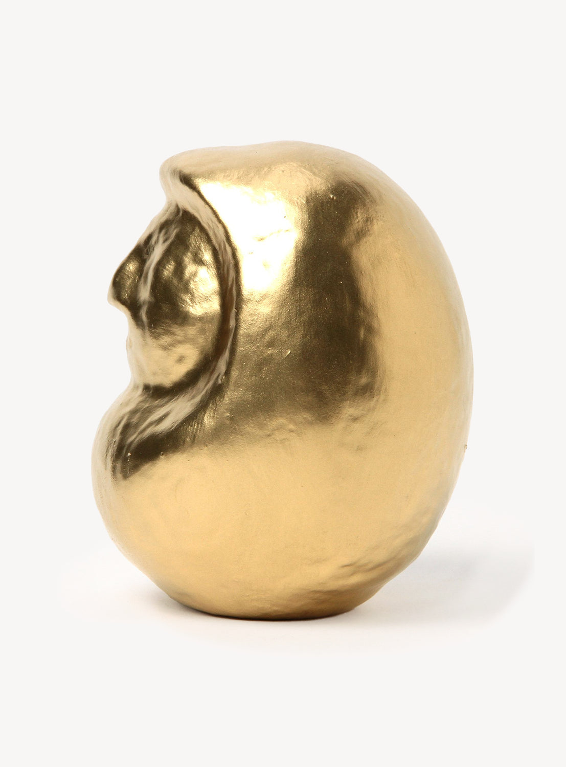 Gold-colored daruma on a white background