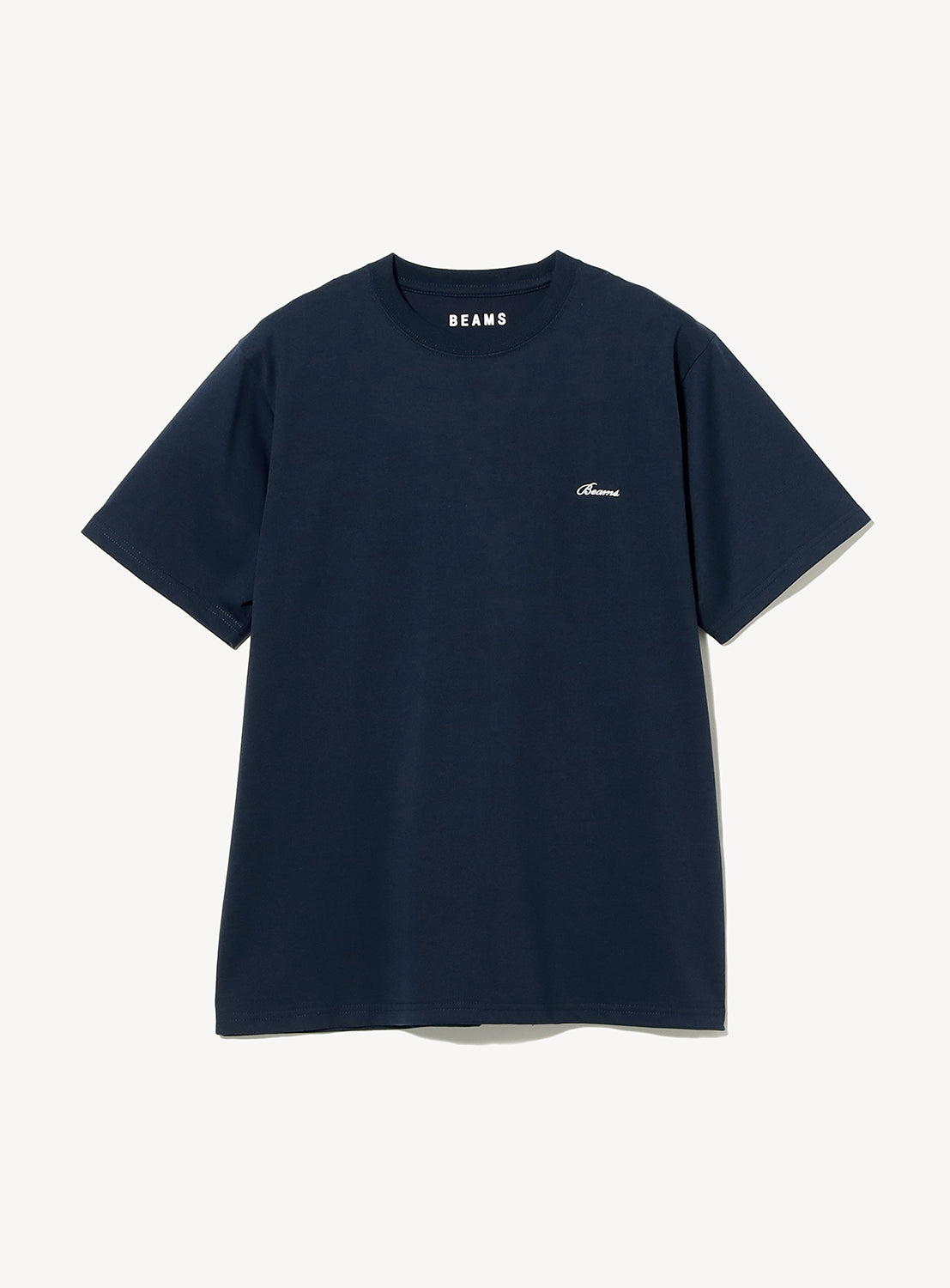 Signature Logo Basic Fit T-Shirt by BEAMS in navy blue with short sleeves and a classic crew neck. Features "BEAMS" printed inside the collar and a small, white embroidered BEAMS logo on the left chest. The shirt is displayed flat against a white background.