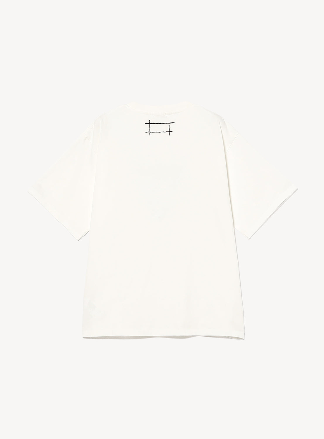 The image shows the back view of the Box Logo T-Shirt by F-LAGSTUF-F, a plain white heavyweight cotton jersey short-sleeve tee. It features a small black stitched rectangular box logo with crossing lines positioned at the top center near the neckline. The background is white.