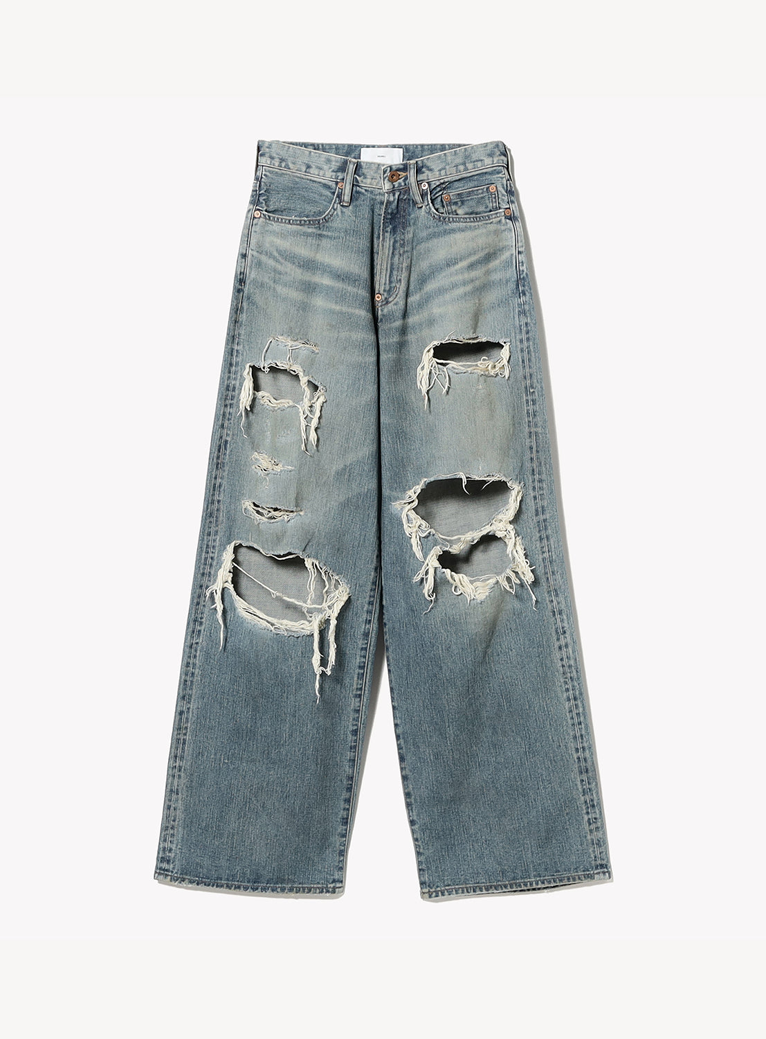 Distressed blue jeans on a white background