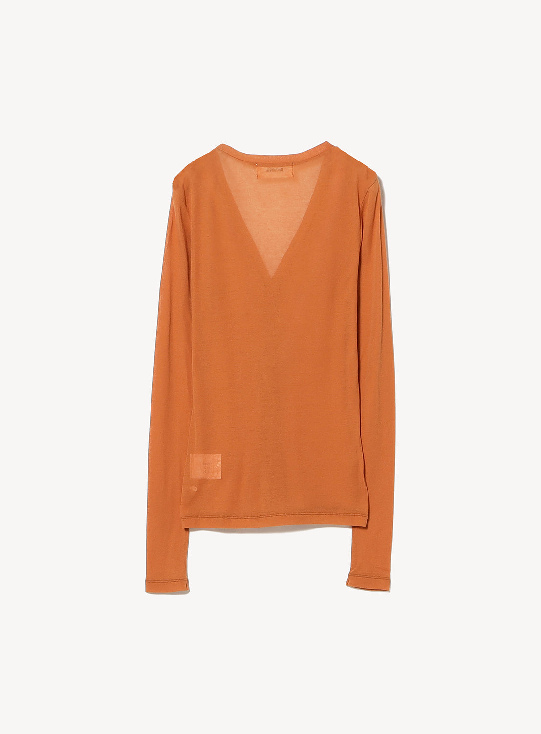 Sheer V-neck cardigan by Ernie Palo in burnt orange, made from lightweight cotton fabric, features a small rectangular patch near the bottom hem and is displayed against a plain white background.