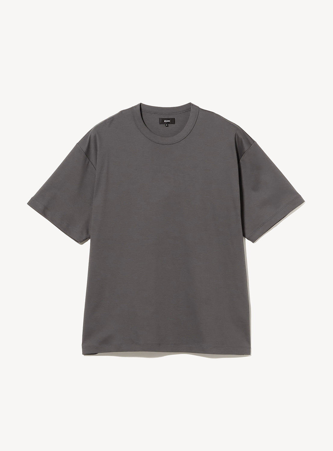 A BEAMS Silky Relaxed Fit Crew Neck T-Shirt in dark gray is displayed flat against a white background. Made from premium fabric, this short-sleeve shirt features a relaxed fit and a plain design with no visible logos or embellishments.