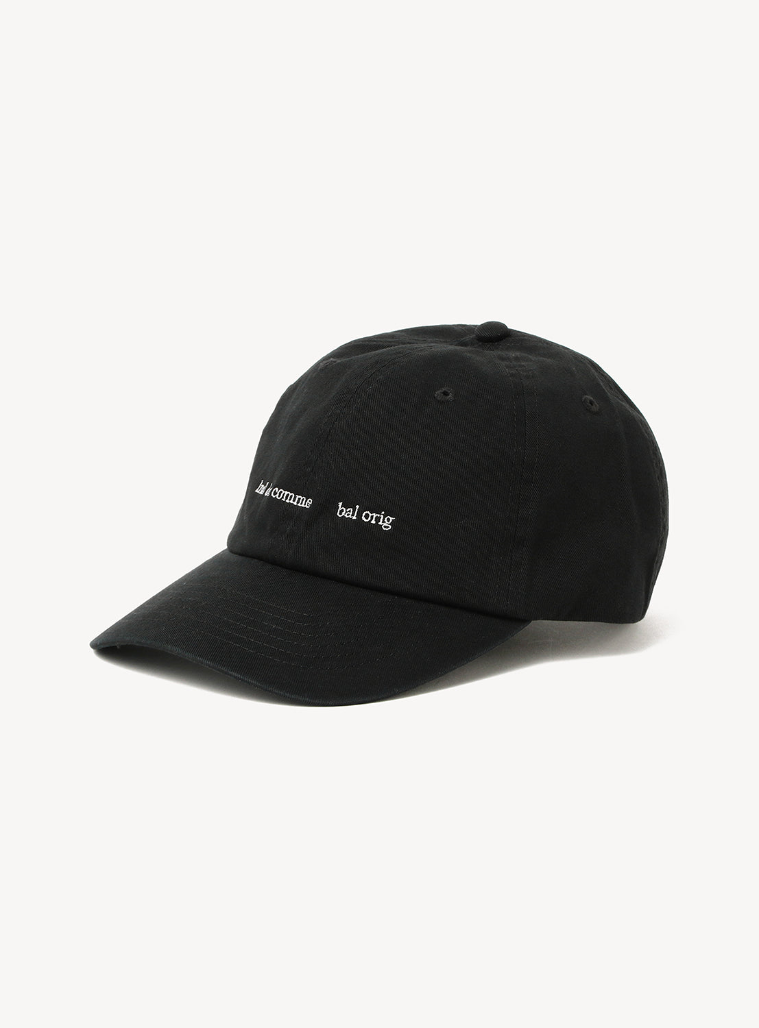Introducing the BAL Cotton 6-Panel Hat: a black cotton twill cap with white embroidered “A’come bal orig.” text on the front. This unstructured, low-profile hat features a relaxed shape and curved brim, offering effortless style and comfort.