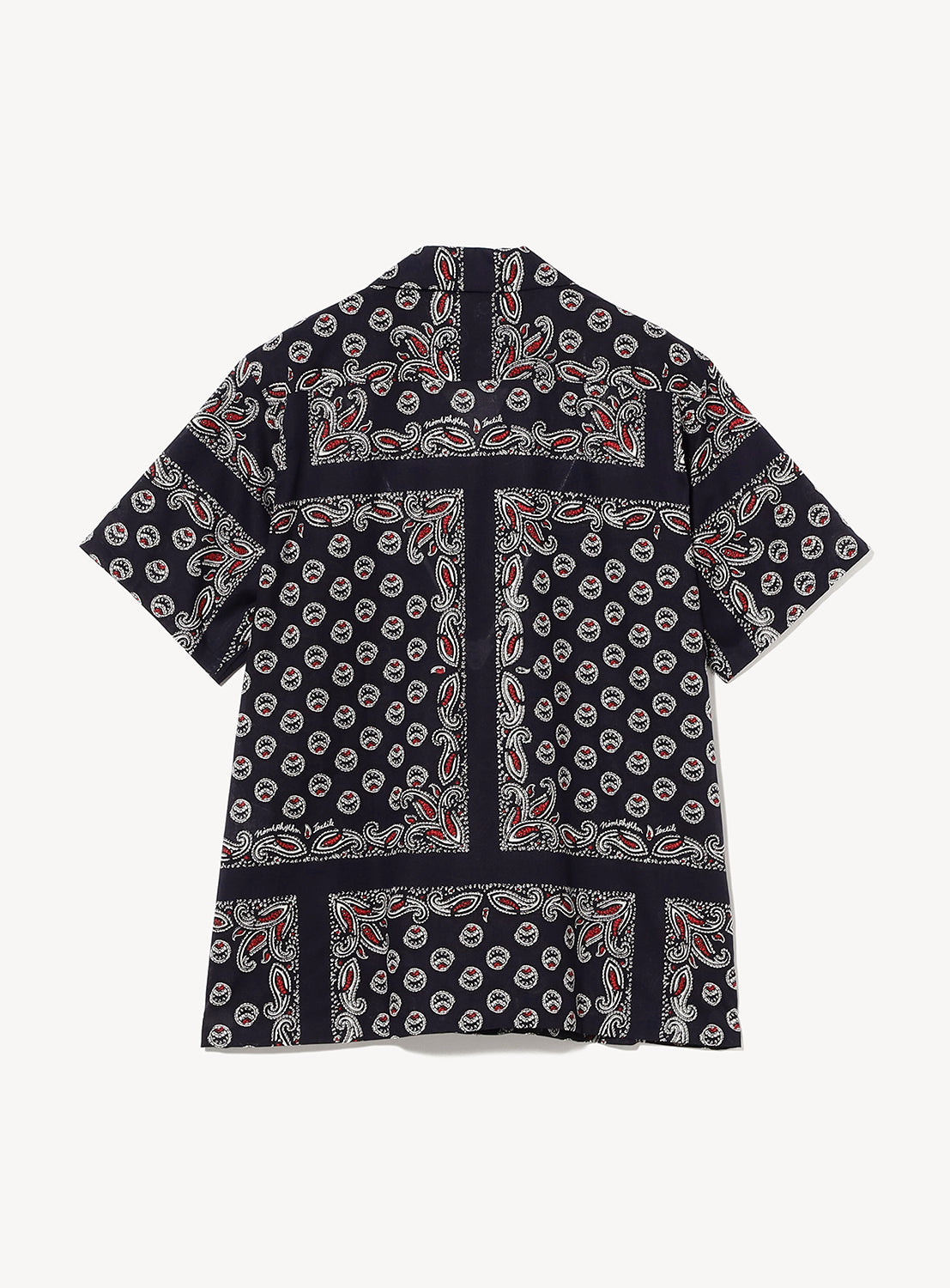 The Paisley Open Collar Shirt by NOMARHYTHM TEXTILE is a short-sleeve shirt with a black base, adorned with a white and red paisley print and dotted bandana pattern. Shown laid flat from the back view.