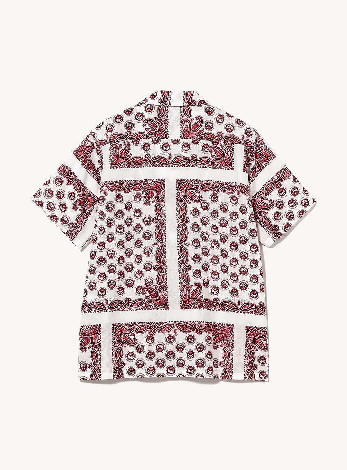The NOMARHYTHM TEXTILE Paisley Open Collar Shirt is a short-sleeved shirt with a white base, adorned with red and black paisley prints and circular motifs in a patchwork arrangement. The shirt is displayed flat, showing the back side.