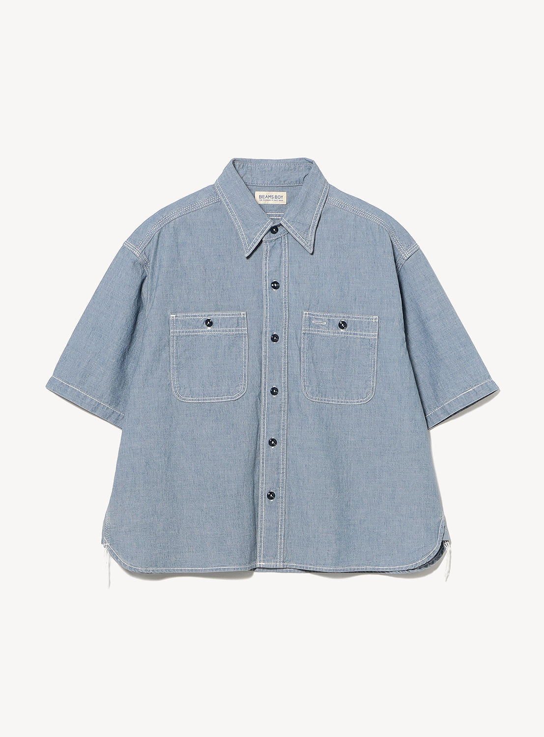 The BEAMS BOY Chambray Short-Sleeve Work Shirt features a relaxed fit, two chest pockets, black buttons, white stitching, and a slightly flared silhouette for casual comfort.