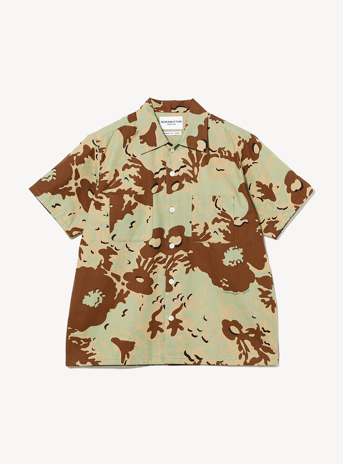 The Camo Flower Open Shirt by NOMARHYTHM TEXTILE is a short-sleeved, button-up shirt featuring a green, brown, and beige camouflage pattern. Made from breathable cotton, it’s shown on a flat white background.