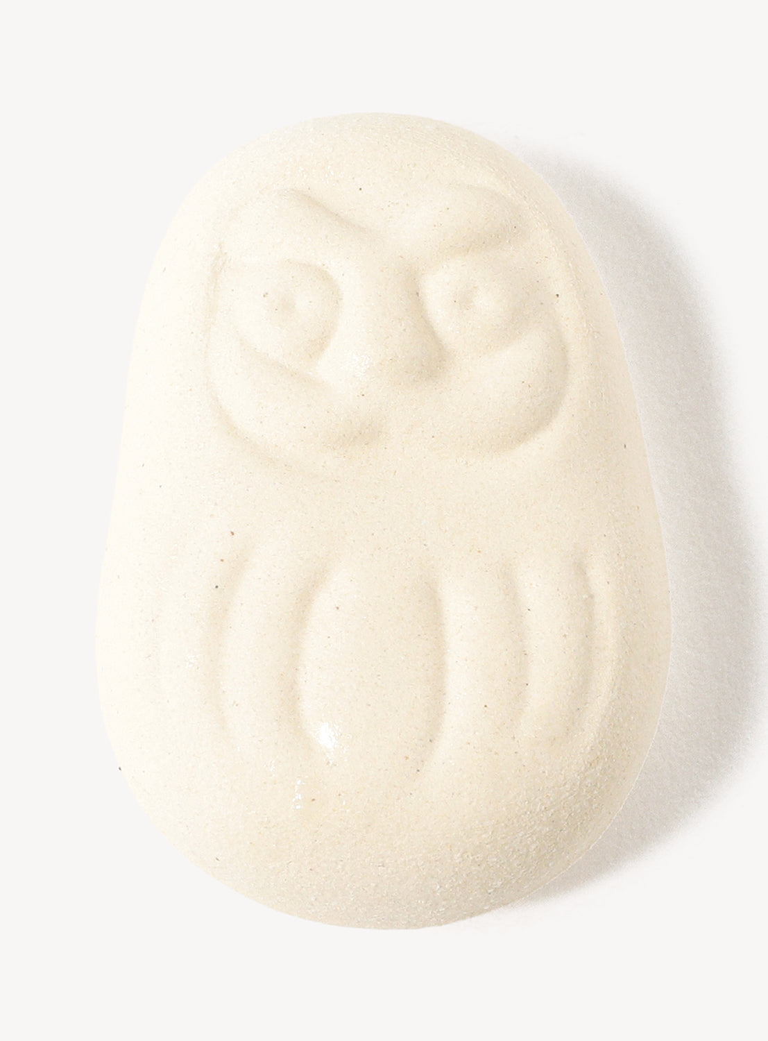 White daruma chopstick rest on a white background