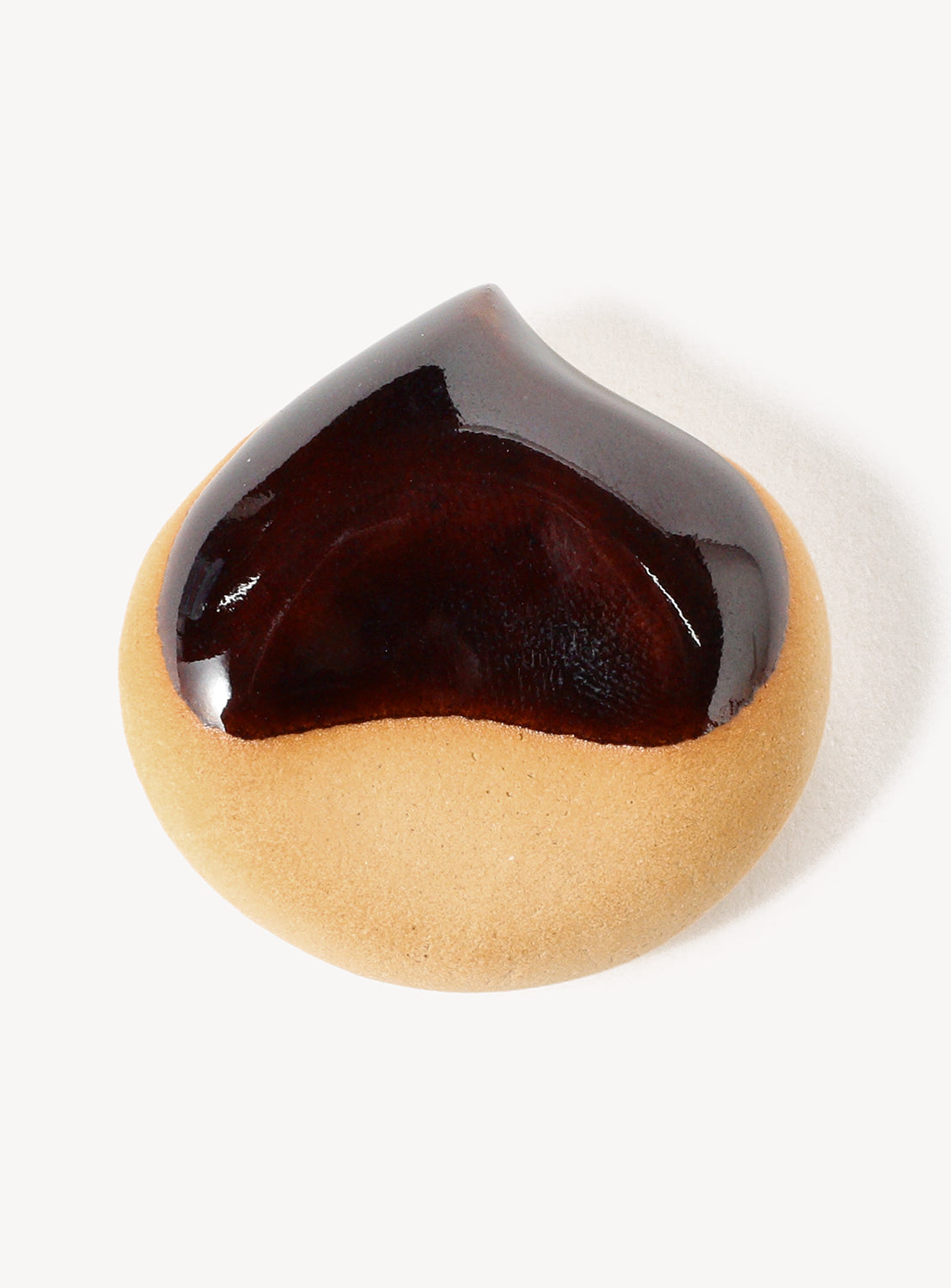 Heart-shaped cookie chopstick rest with chocolate glaze on a white background