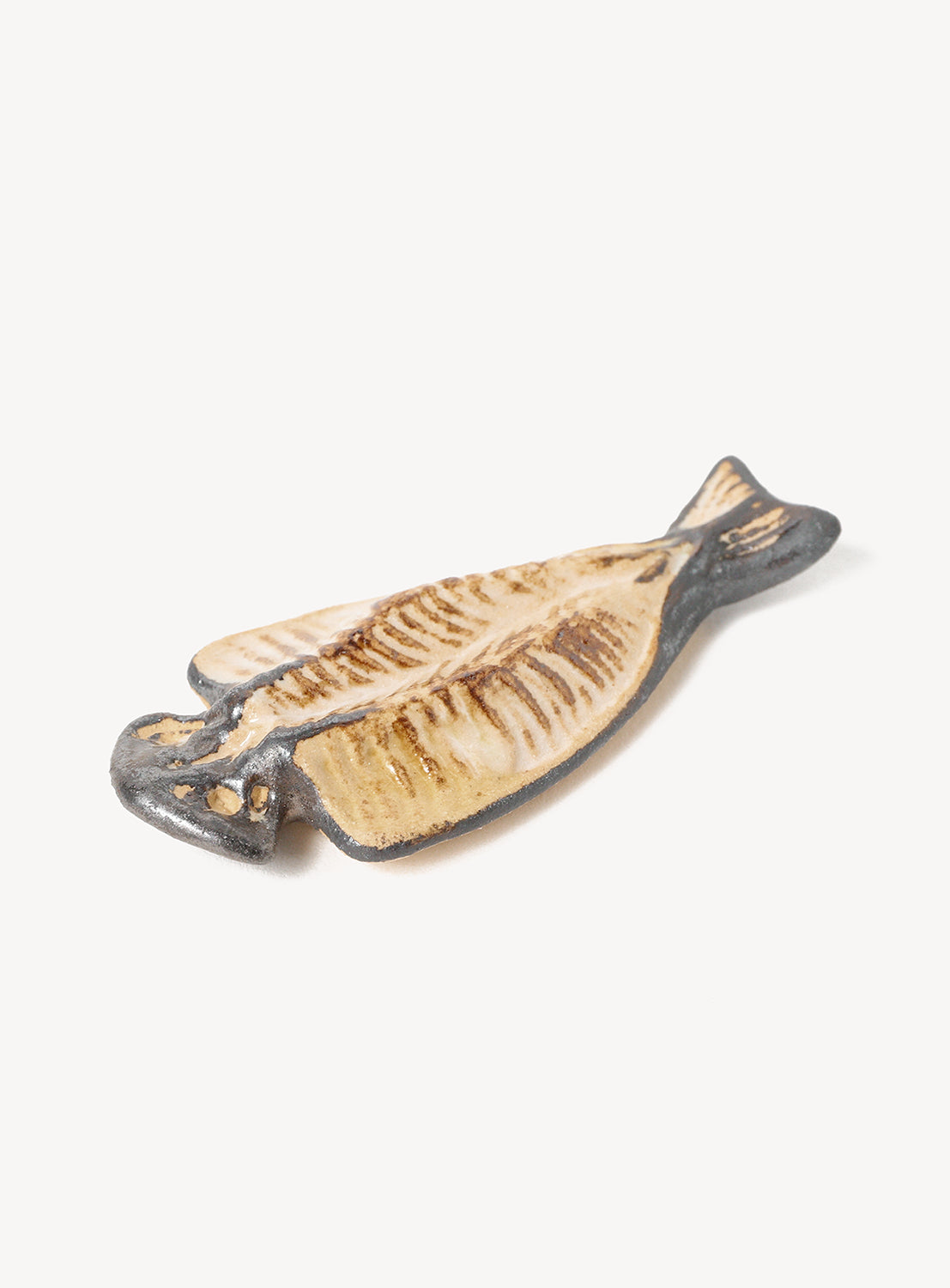 Fish-shaped chopstick rest on a white background