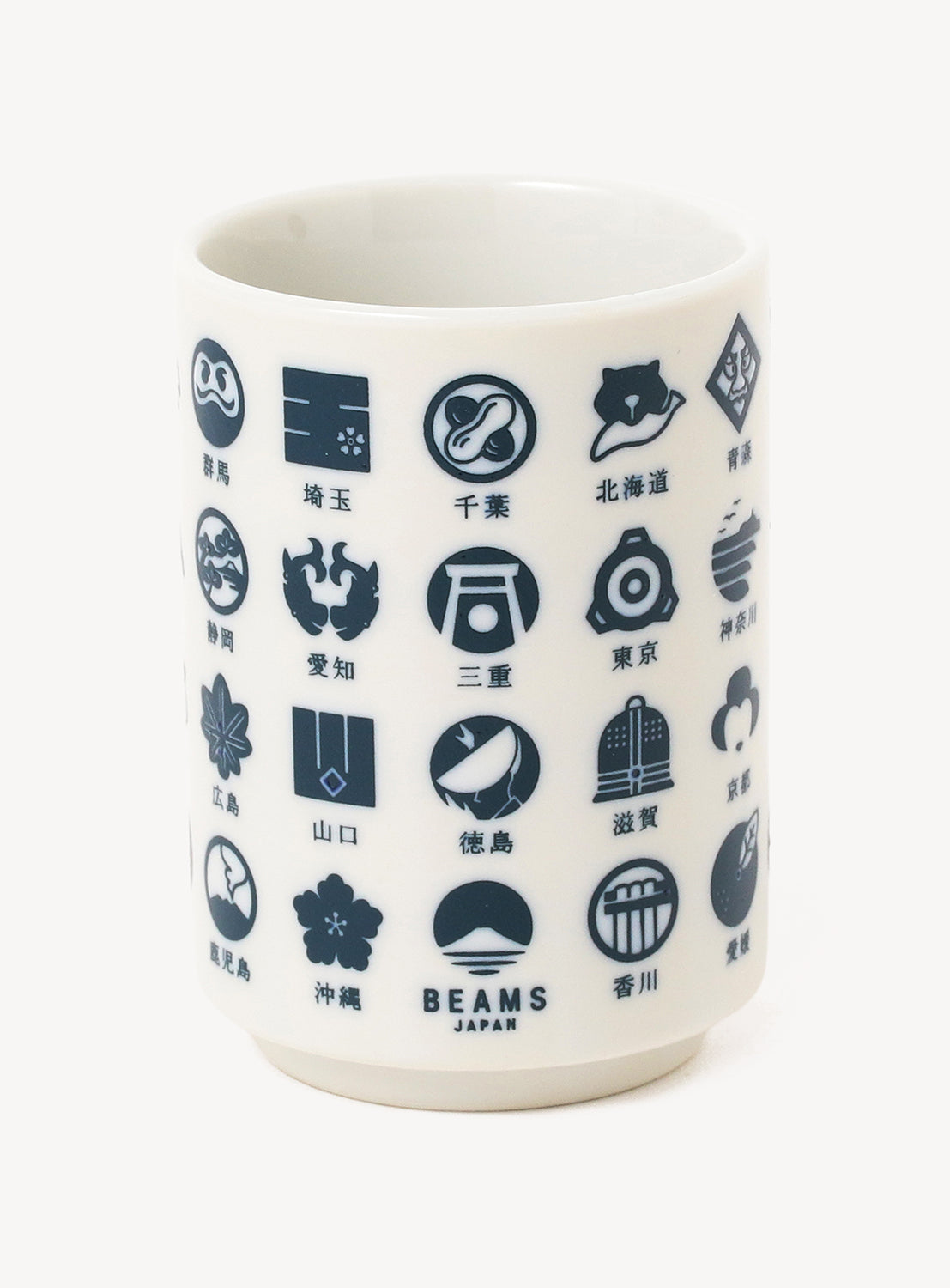 White mug with navy geometric and icon patterns on a white background