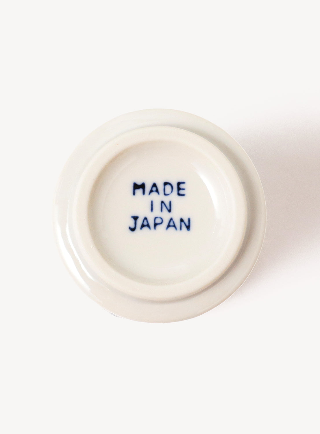 White ceramic item with 'MADE IN JAPAN' text on a white background