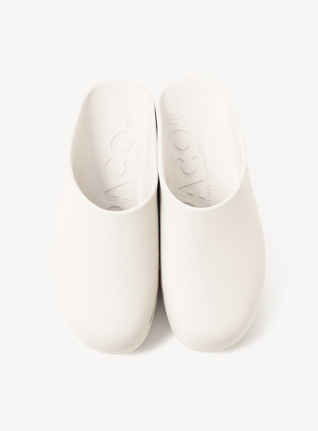 The PPACO LUX-1 Closed-Toe Slide Sandals, in white with cushioned construction and rounded toes, are shown side by side on a plain background, offering lightweight comfort for everyday wear.