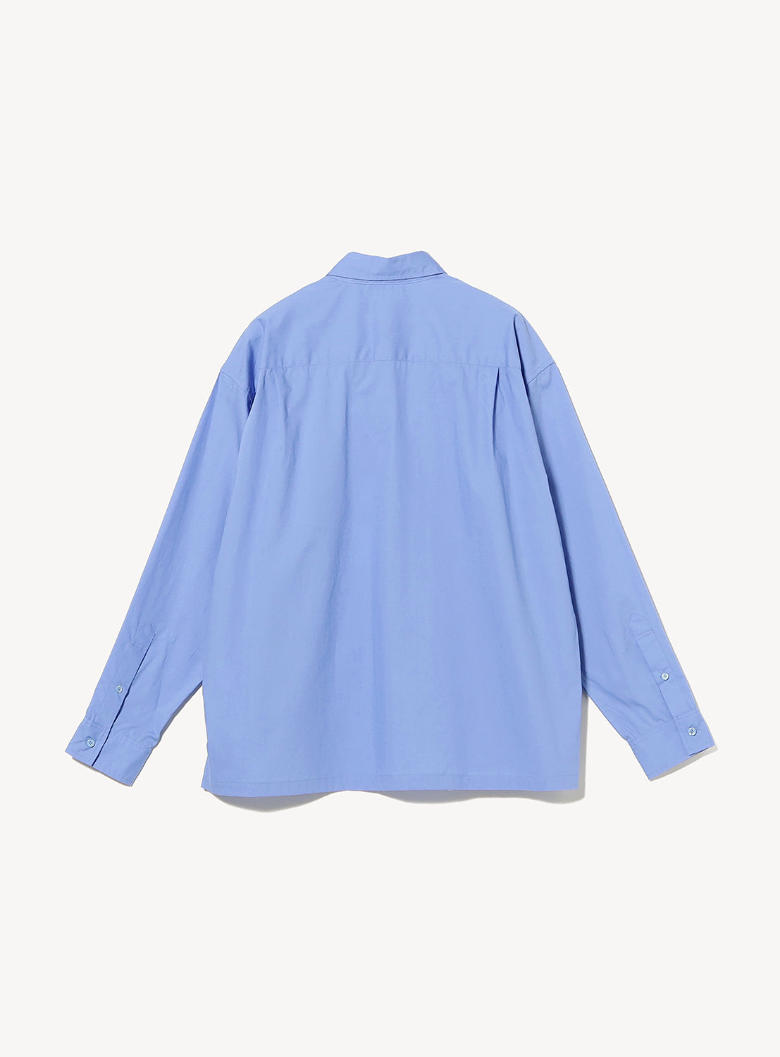 The TTT MSW Regular Collar Shirt is displayed from the back, laid flat on a white background. This light blue, long-sleeve button-up features a modern fit with a classic collar and buttoned sleeve cuffs, creating a relaxed silhouette that makes it a versatile genderless piece.
