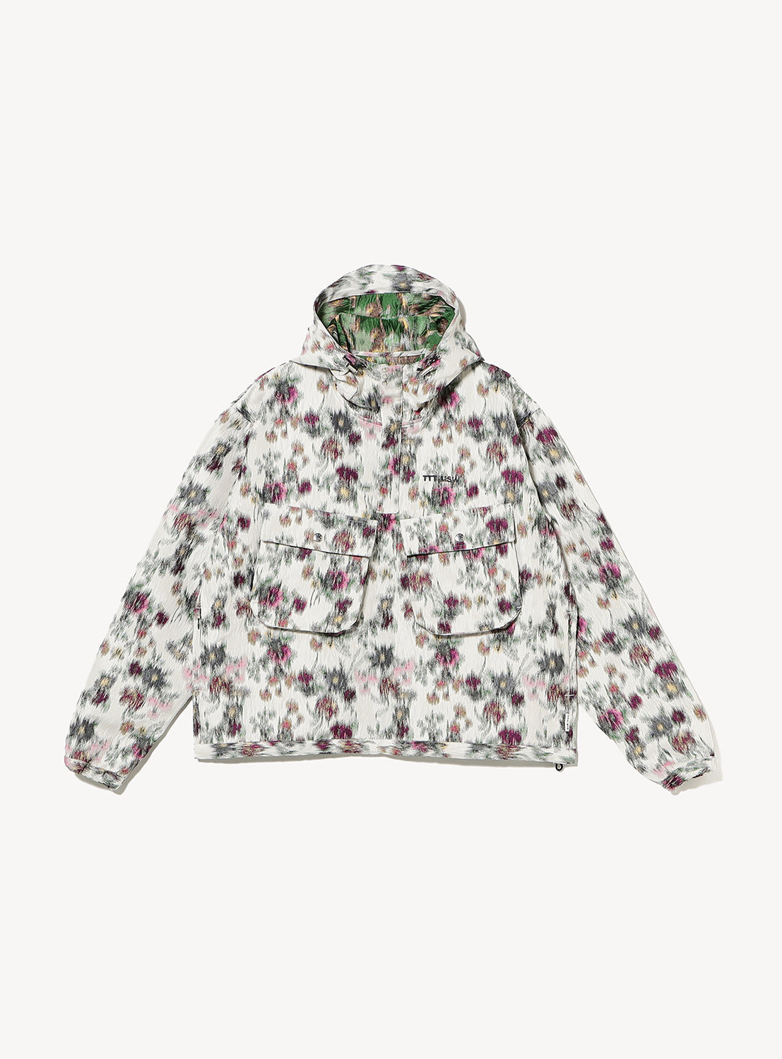 The TTT MSW Flower Jacquard Anorak Hoodie is Italian-made with a loose fit, white base, abstract floral pattern in purple, green, and black, two large front pockets, and a quarter-zip design.