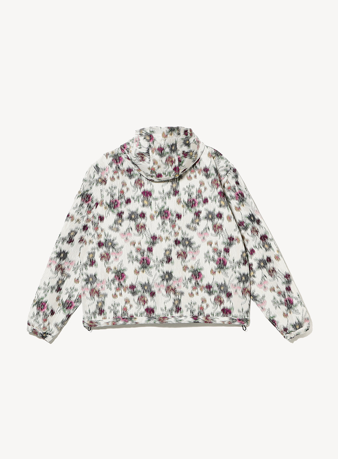 The TTT MSW Flower Jacquard Anorak Hoodie is a lightweight Italian-made hoodie with long sleeves, an abstract floral jacquard in pink, green, and black on white, a loose fit, and elastic cuffs and hem for comfort.