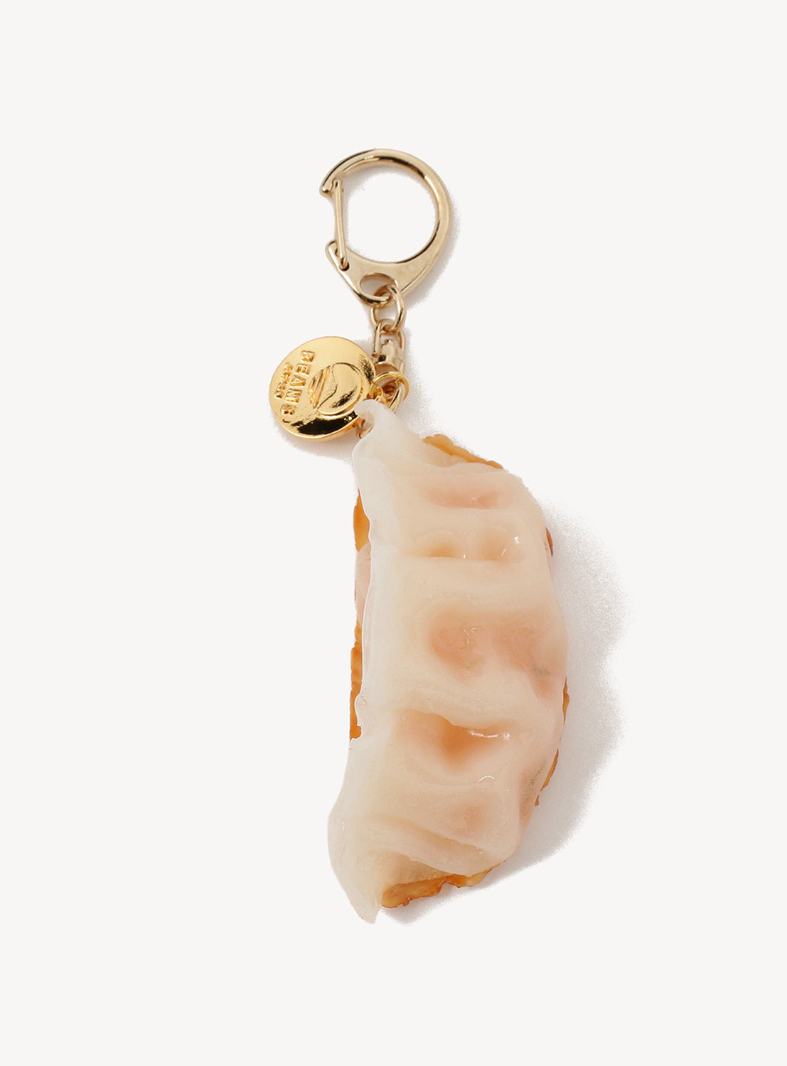 Gyoza-shaped keychain with gold clasp on a white background