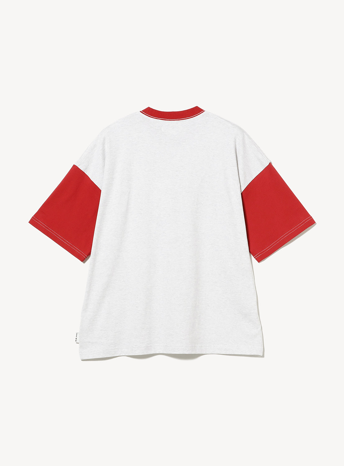 The TTT MSW Wave Logo Ringer T-Shirt showcases a crisp white body with striking red sleeves and a coordinating red collar, displayed from the back against a plain white background. This retro-inspired tee channels classic streetwear aesthetics, making it an essential for anyone seeking timeless style with attitude.
