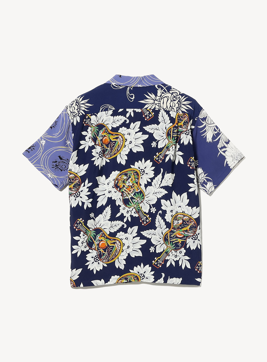 The SUN SURF Exclusive Patchwork Aloha Shirt 26SS features bold navy, large white flowers, tattoo-style women, and purple waves—a modern update to vintage aloha shirts. Back of the shirt is shown. Brand: SUN SURF.