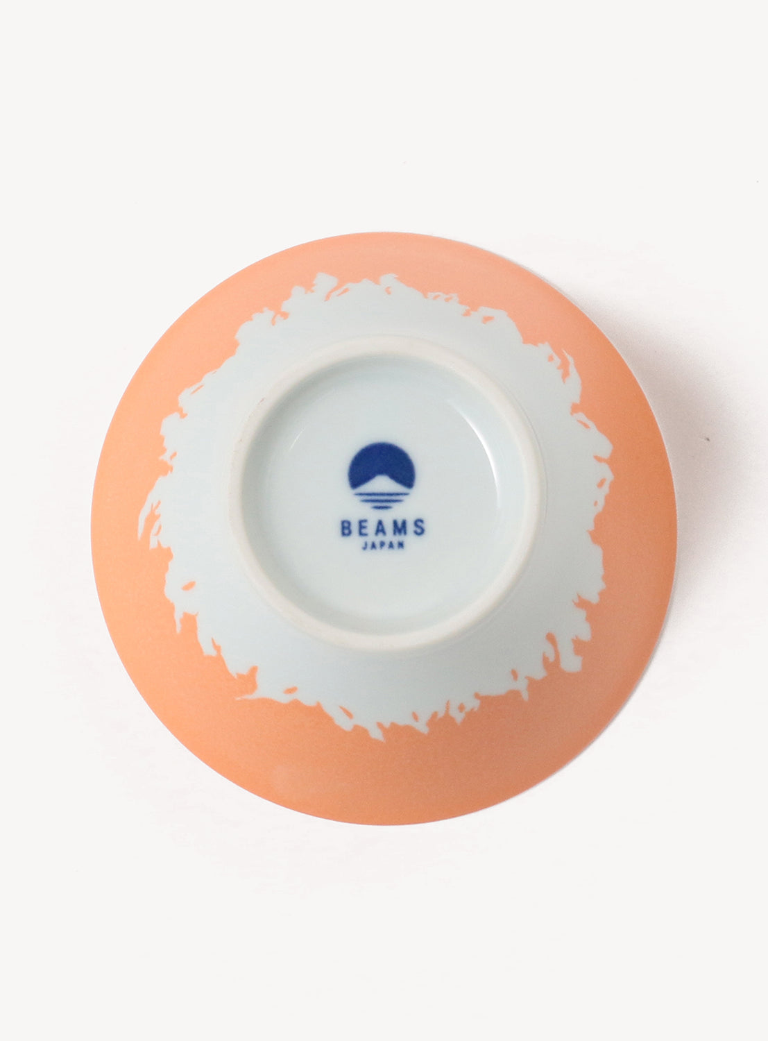 Ceramic bowl with a white interior and peach exterior, featuring the Beams Japan logo.