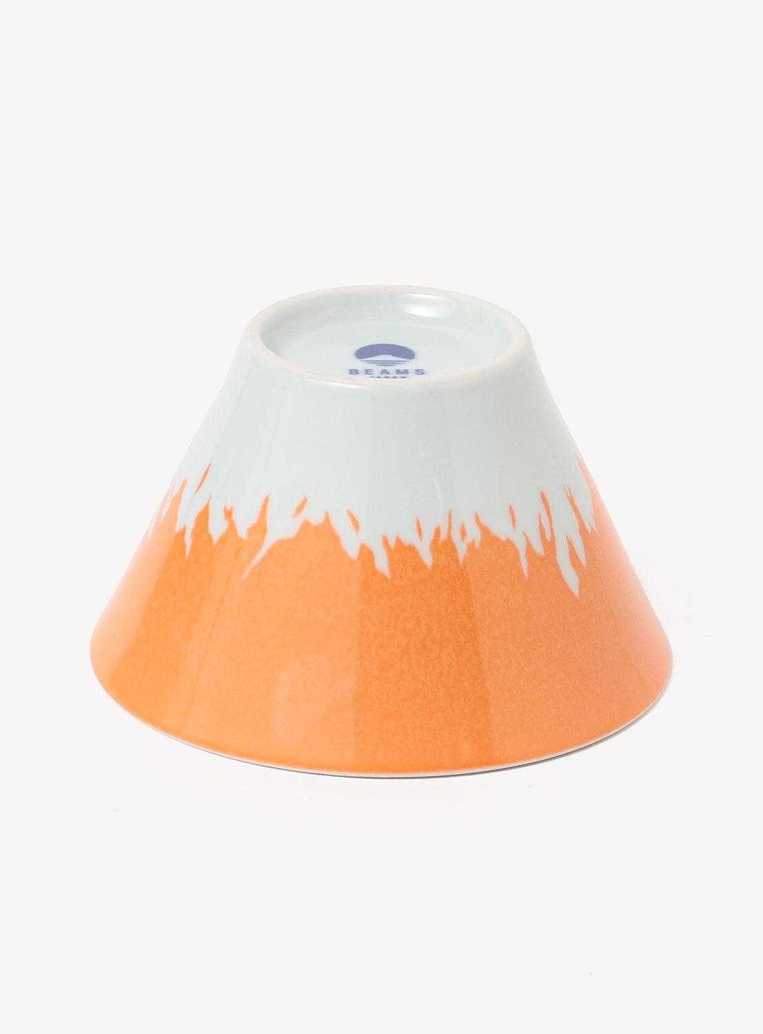 Ceramic bowl with white top and orange bottom on a white background
