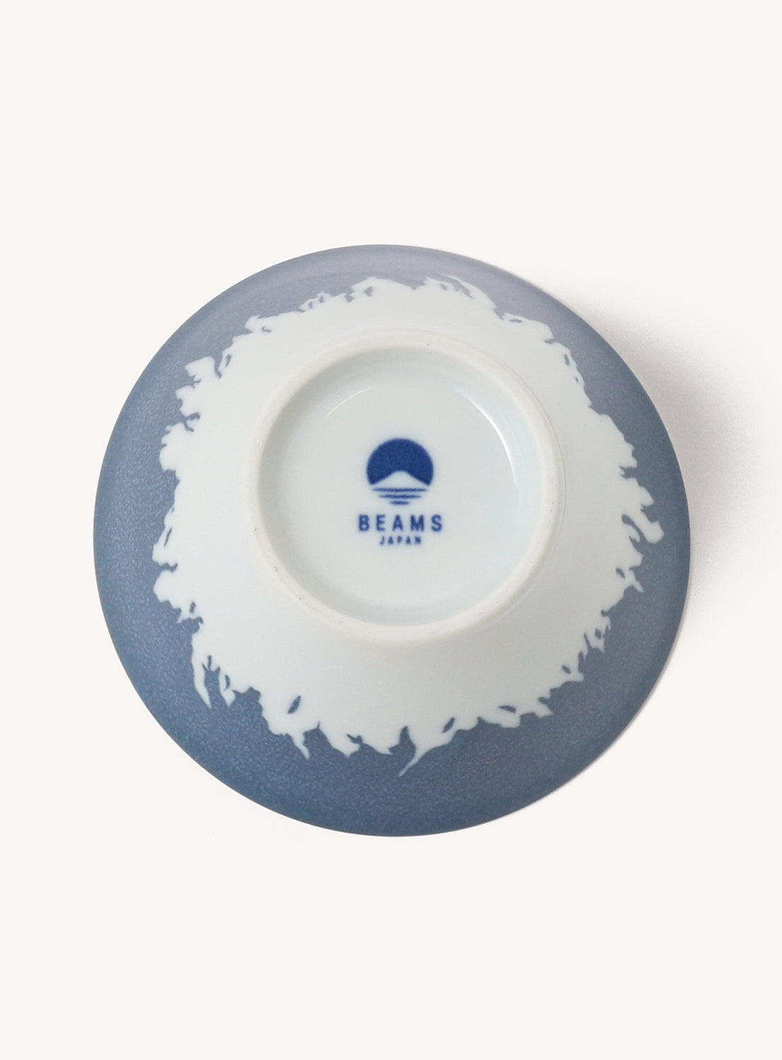 Ceramic bowl with blue rim and white interior, featuring a logo, on a white background