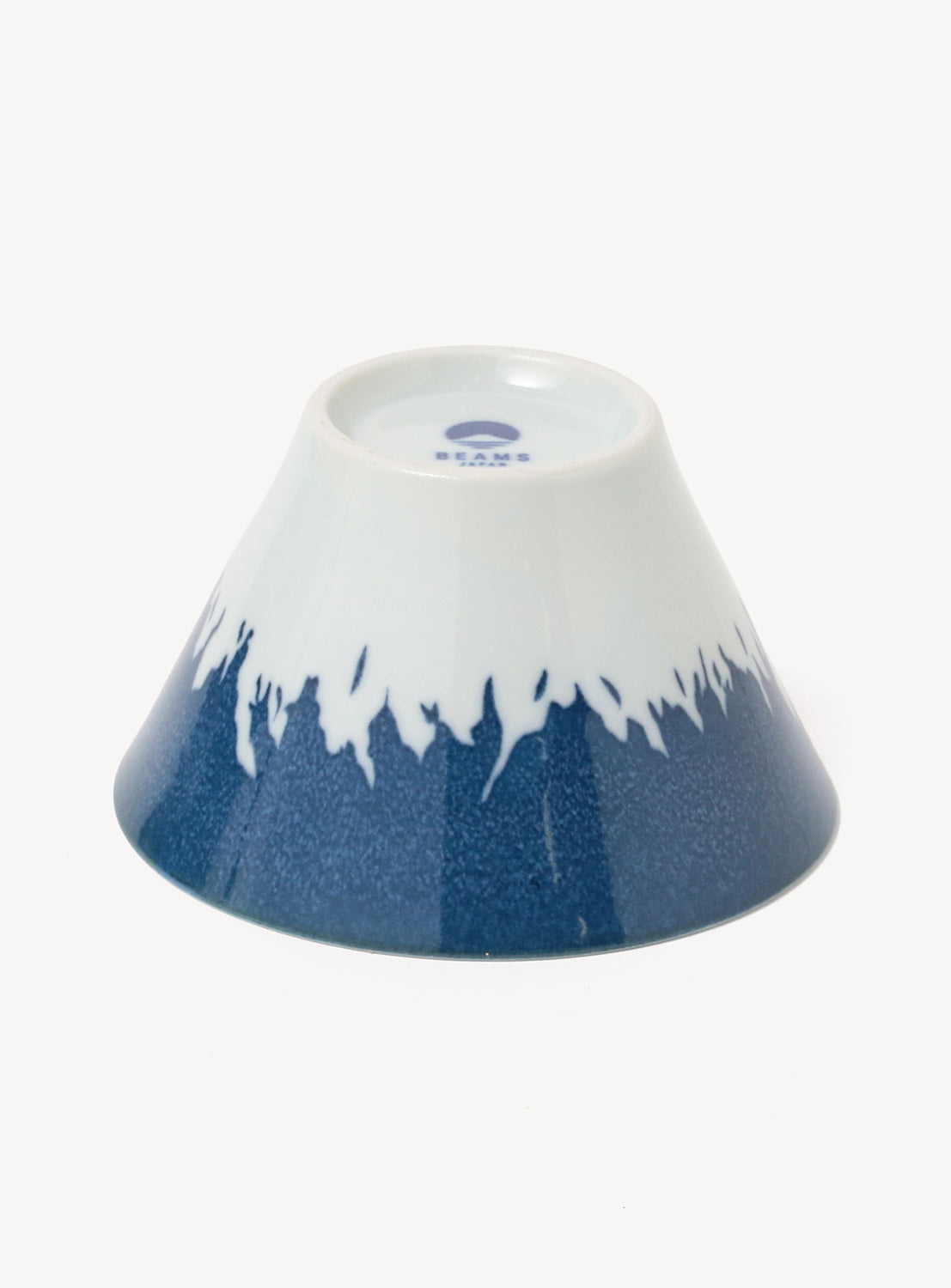 Cone-shaped ceramic bowl with blue and white design on a white background