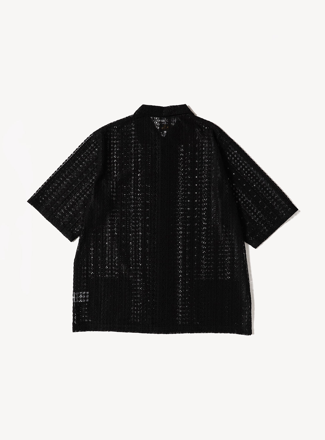 Back view of a black short-sleeve lace shirt with a relaxed boxy silhouette. The sheer Raschel lace construction features an intricate vertical knit pattern throughout, highlighting the lightweight, breathable texture and airy design.