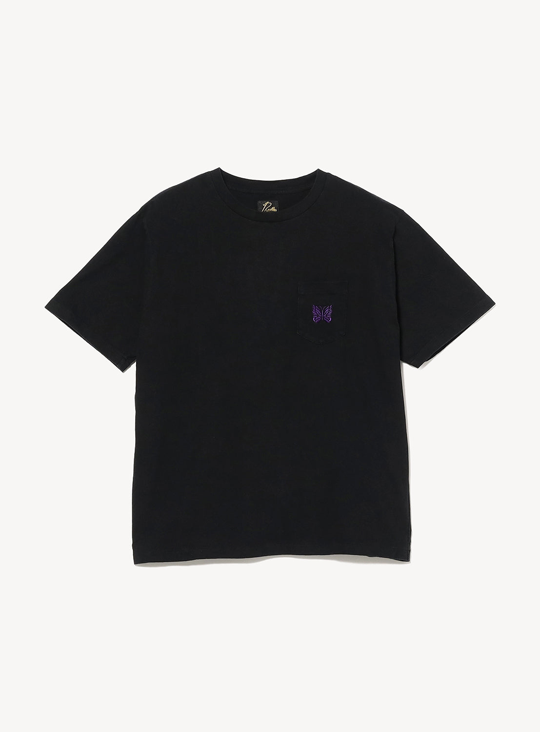 Front view of a black crew neck T-shirt with a relaxed fit. Features a chest patch pocket accented with NEEDLES' signature embroidered Papillon butterfly logo in purple, creating a clean, minimalist look.