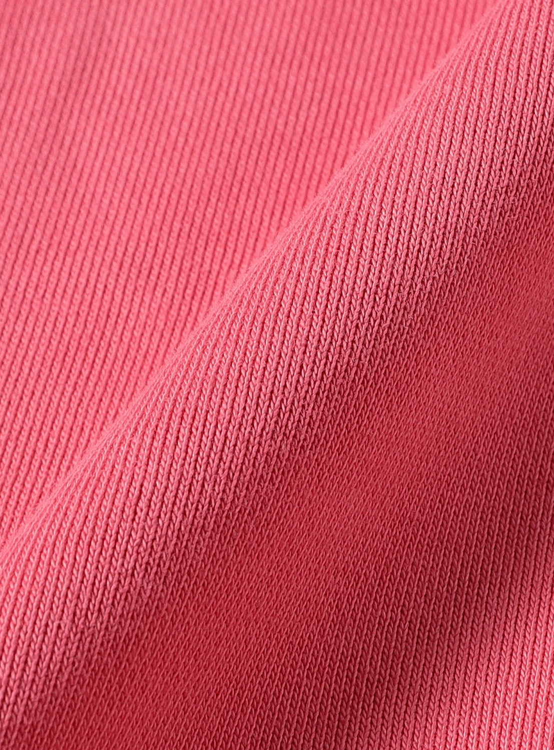 Close-up of the pink knit fabric of a Faded Souvenir Half Zip Pullover by BEAMS, showing a vintage-inspired diagonal texture.
