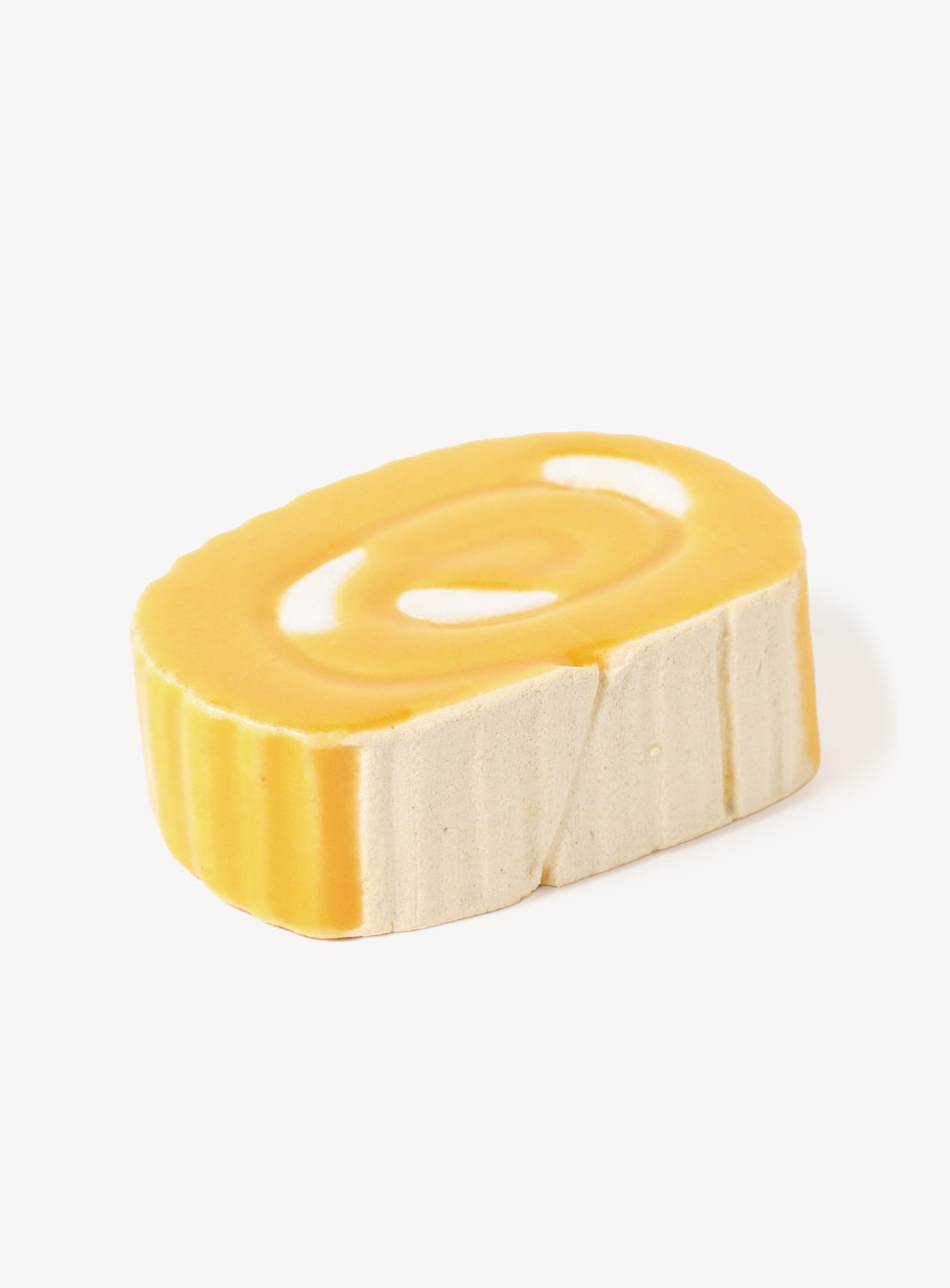 Yellow ceramic chopstick rest on a white background