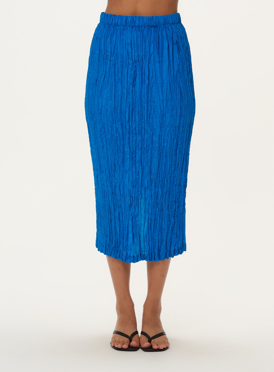 Front view of a model wearing a high-waisted, crinkled blue midi skirt.